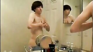 Watch this young stud stroke his cock and masturbate in the shower like a pro!