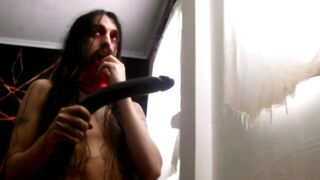 Scarlet deepthroats satan's manstick and takes it deep in his throat